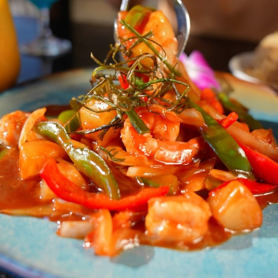 Close-up of Maya Thai Eatery's sweet and sour shrimp with bell peppers and onions.